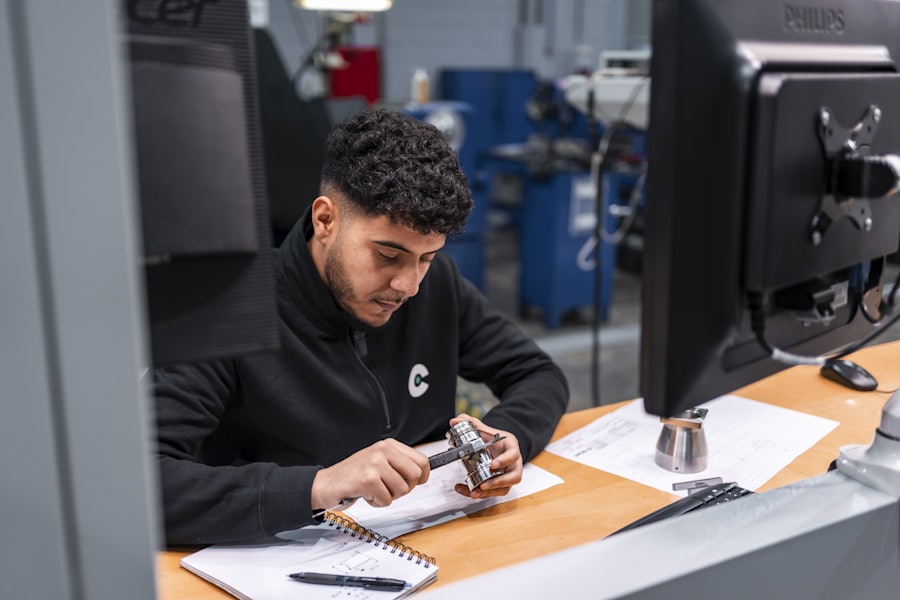 Engineer examining a component against technical notes
