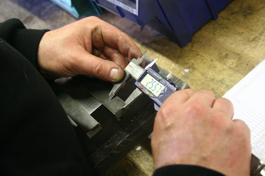 A machined part being measured with a digital caliper